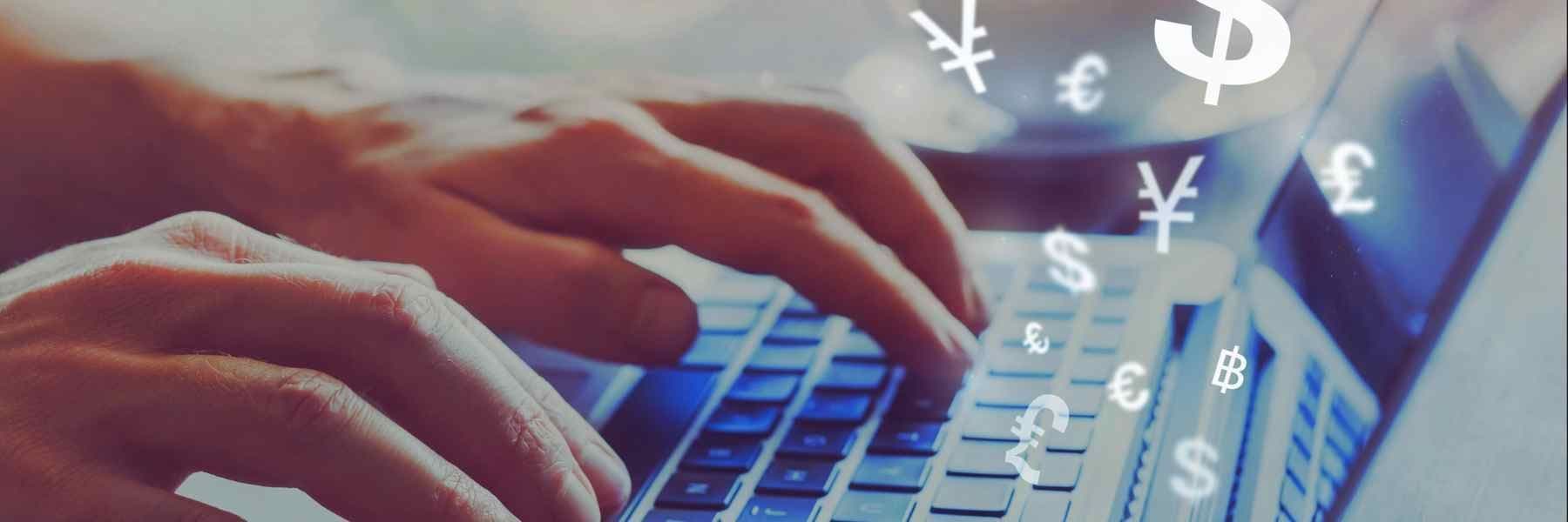 Hands typing on a laptop keyboard with floating symbols of various world currencies (dollar, euro, pound, yen, bitcoin).